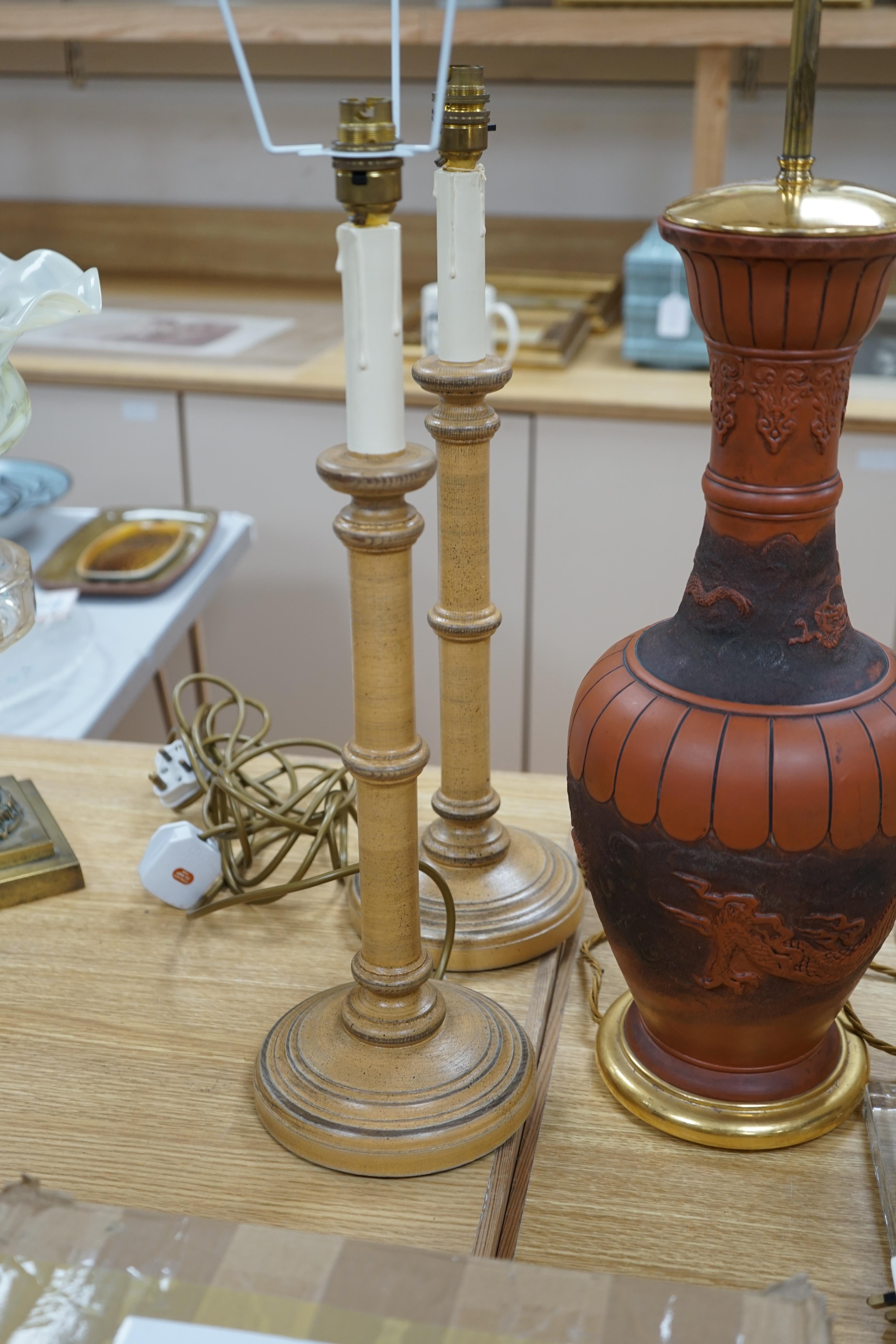 A Japanese terracotta dragon lamp base, two glass and a pair of wooden candlestick lamp bases, tallest 77cm high including light fitting (5). Condition - fair to good